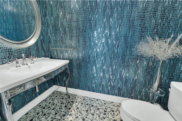 bathroom with tile patterned flooring, toilet, and sink