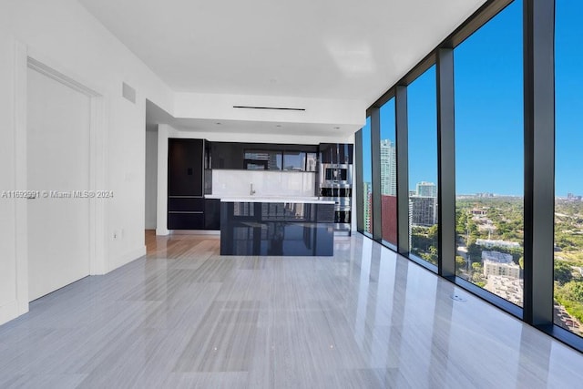 interior space with a wall of windows and sink