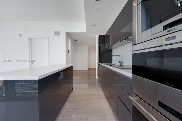 1451 Brickell Ave Unit 2706, Miami, FL 33131 - kitchen featuring modern cabinets, light countertops, stainless steel microwave, and a center island