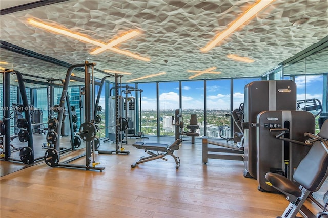 1451 Brickell Ave Unit 2706, Miami, FL 33131 - workout area with expansive windows and hardwood / wood-style flooring