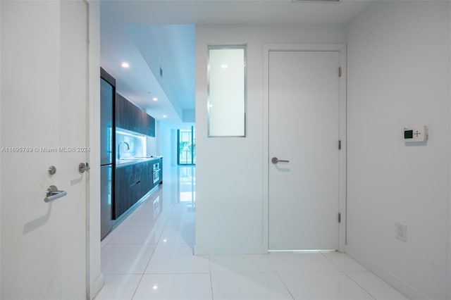 corridor featuring light tile patterned flooring