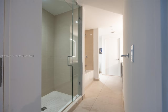 bathroom featuring tile patterned floors and shower with separate bathtub