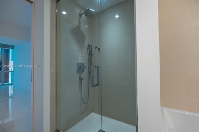 bathroom featuring shower with separate bathtub