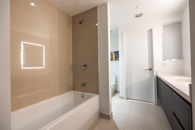 full bathroom with toilet, vanity, tile patterned floors, and tiled shower / bath combo