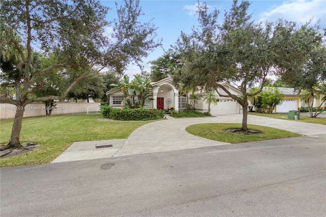 obstructed view of property with a front yard and a garage