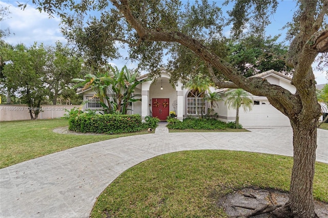 view of front of home with a front yard and a garage