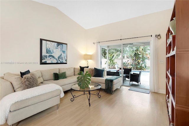 living room with vaulted ceiling and light wood-type flooring