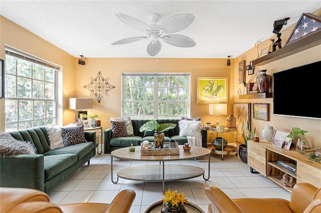 living room with light tile patterned floors, a textured ceiling, and ceiling fan