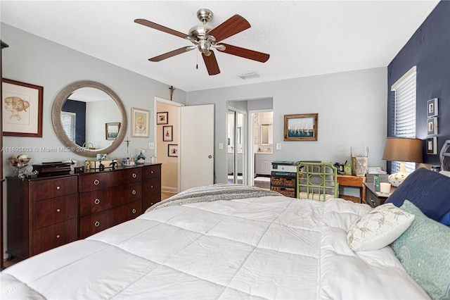 bedroom with a textured ceiling and ceiling fan