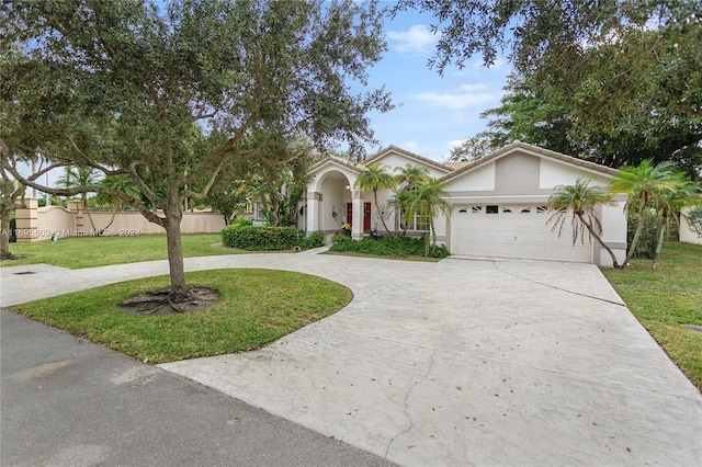 view of front of house with a garage and a front lawn