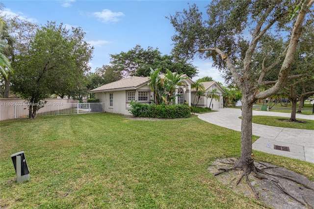 view of front of property featuring a garage and a front lawn