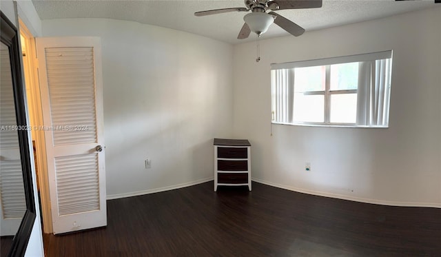 spare room with ceiling fan, dark hardwood / wood-style flooring, and a textured ceiling