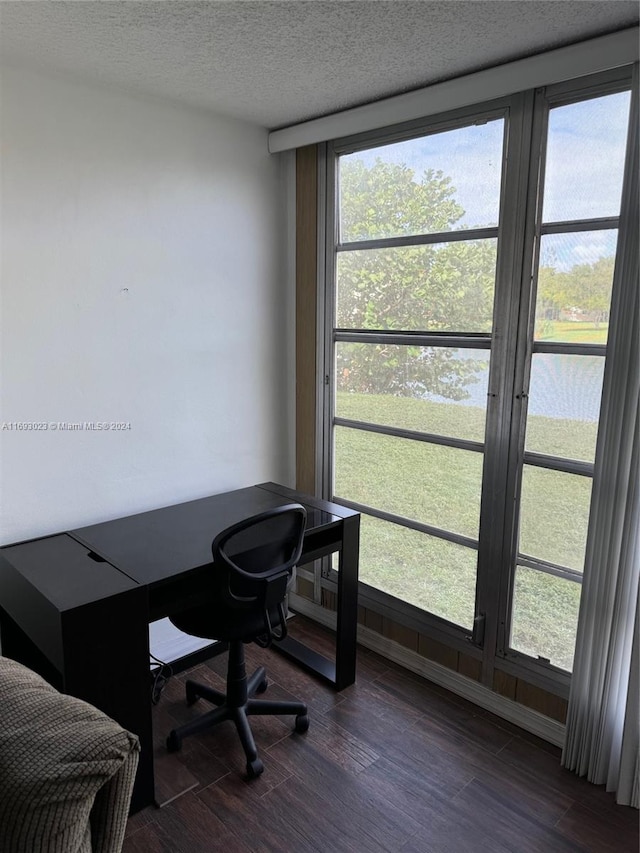 home office with dark hardwood / wood-style floors and a textured ceiling