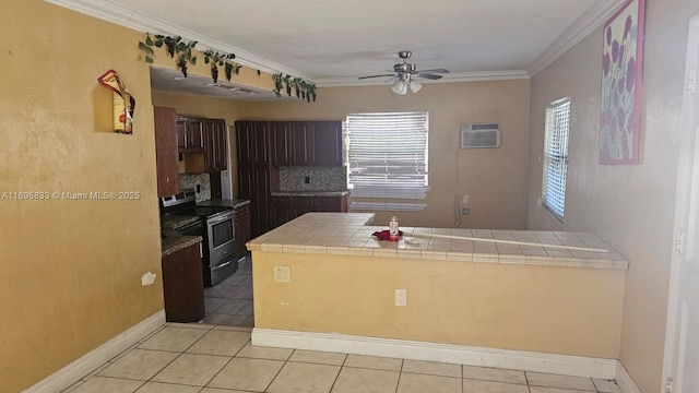 kitchen with tile countertops, a peninsula, light tile patterned flooring, stainless steel range with electric cooktop, and crown molding