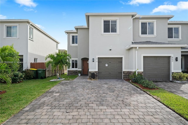 view of front of property with a garage and a front lawn