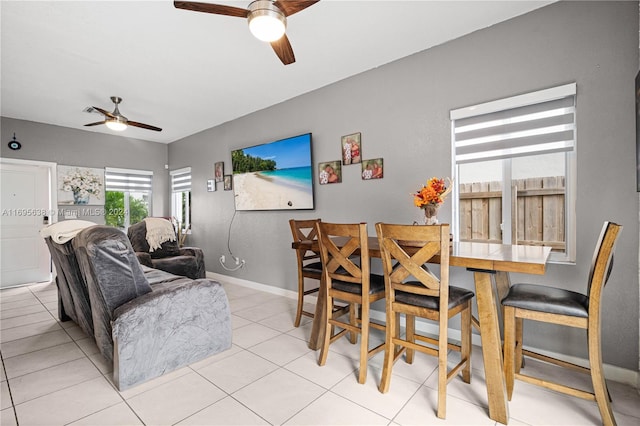 dining space with ceiling fan and light tile patterned flooring