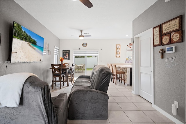 living room with ceiling fan and light tile patterned flooring