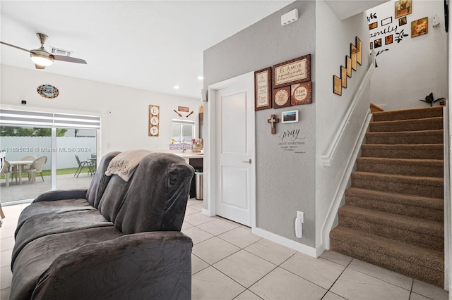 tiled living room featuring ceiling fan