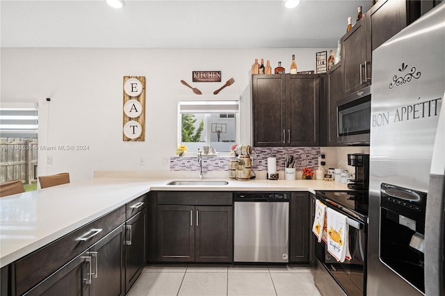 kitchen featuring light tile patterned floors, dark brown cabinetry, sink, and appliances with stainless steel finishes