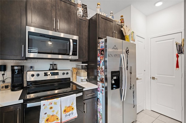 kitchen featuring appliances with stainless steel finishes, dark brown cabinetry, and light tile patterned flooring