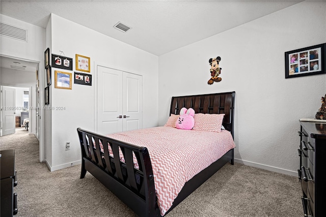 carpeted bedroom with a closet