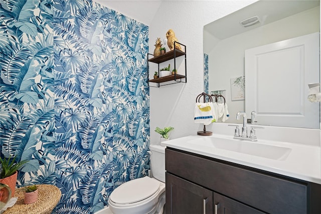 bathroom with vanity and toilet