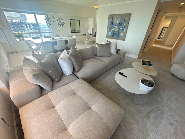 carpeted living room with crown molding