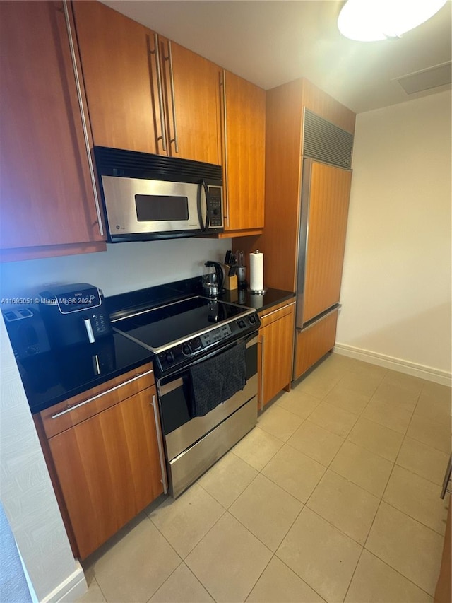 kitchen featuring light tile patterned floors and stainless steel appliances