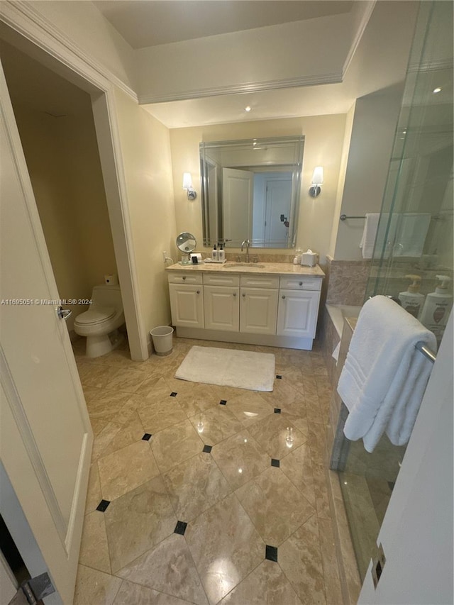 bathroom with a tub to relax in, vanity, and toilet