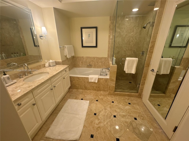 bathroom featuring shower with separate bathtub and vanity