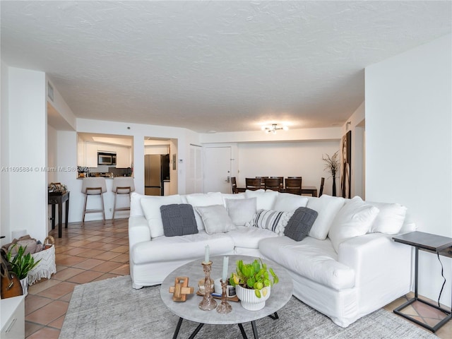 living room with light tile patterned floors and a textured ceiling