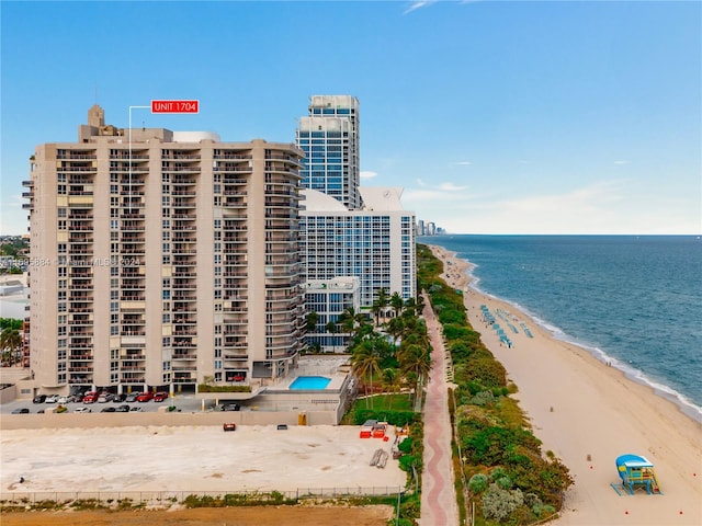 exterior space with a water view and a view of the beach