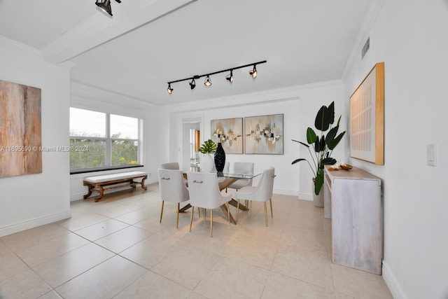 tiled dining area featuring crown molding