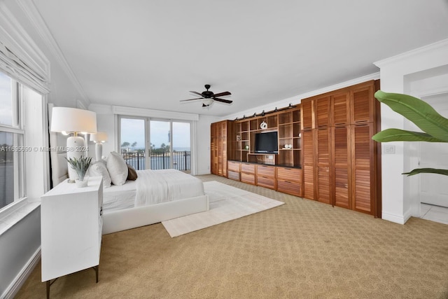 unfurnished bedroom featuring carpet flooring, ceiling fan, access to outside, and ornamental molding