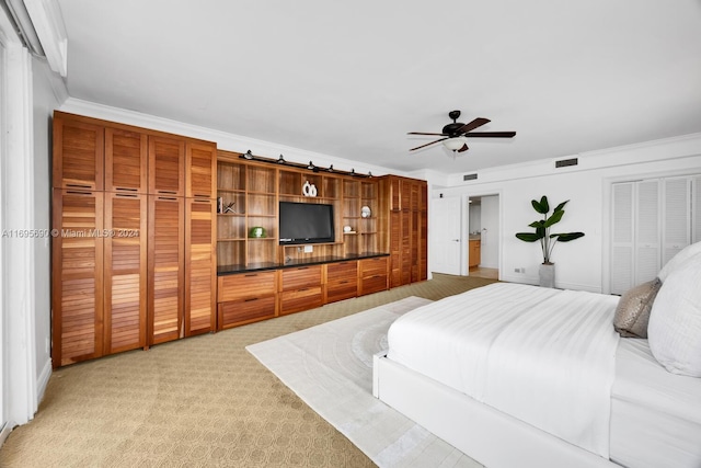 bedroom with ceiling fan, ornamental molding, and carpet floors