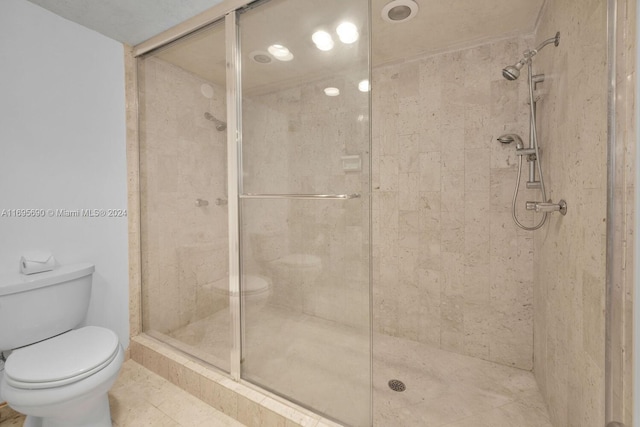 bathroom featuring toilet and walk in shower