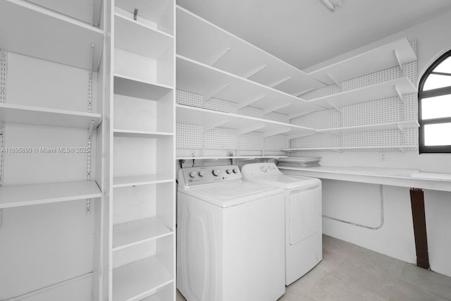 clothes washing area featuring laundry area, separate washer and dryer, and tile patterned floors