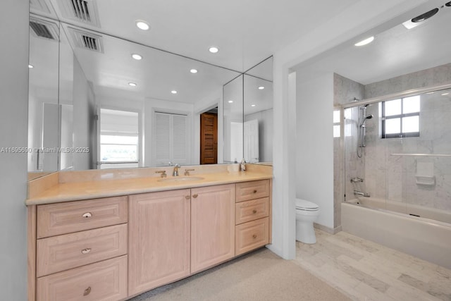 bathroom featuring bath / shower combo with glass door, recessed lighting, visible vents, toilet, and vanity