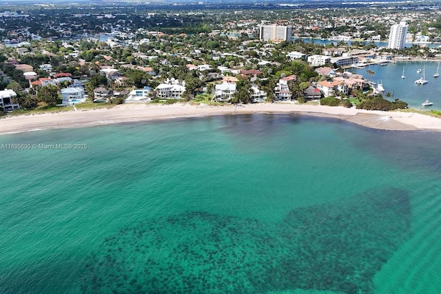 aerial view featuring a view of the beach, a water view, and a view of city