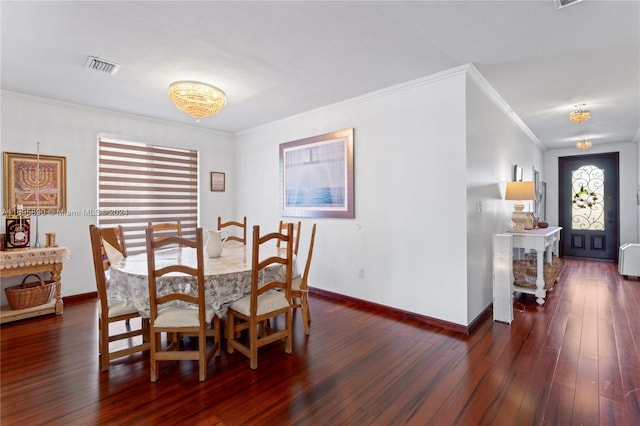 dining space featuring dark hardwood / wood-style flooring and crown molding