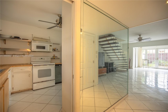 kitchen featuring ceiling fan, light tile patterned flooring, and white appliances