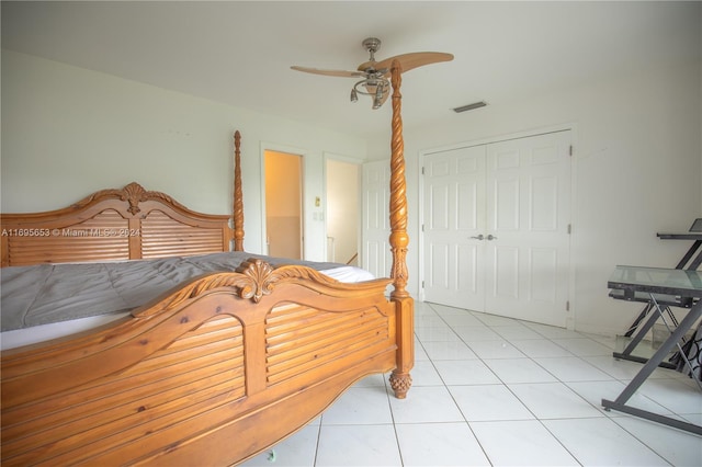 bedroom with ceiling fan, a closet, and light tile patterned flooring