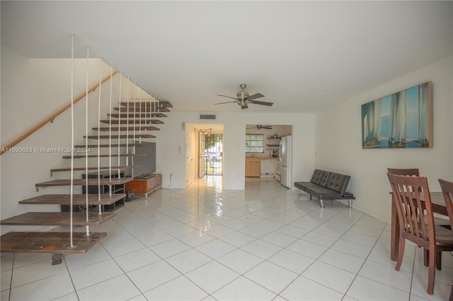 living room with ceiling fan and tile patterned flooring