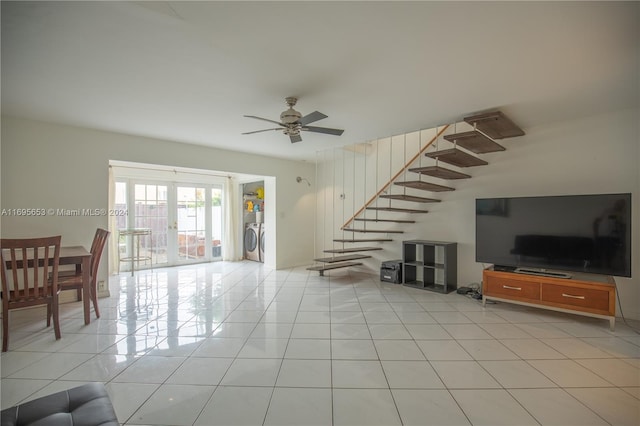 living room featuring light tile patterned floors, french doors, washer / clothes dryer, and ceiling fan