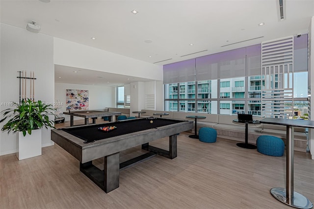 game room with billiards and light hardwood / wood-style flooring