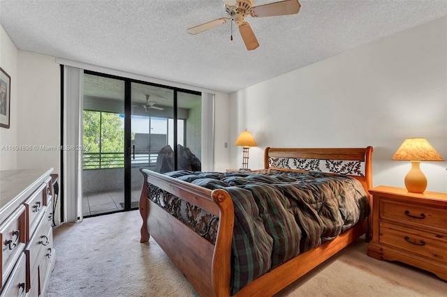 bedroom featuring a textured ceiling, ceiling fan, access to exterior, and light carpet