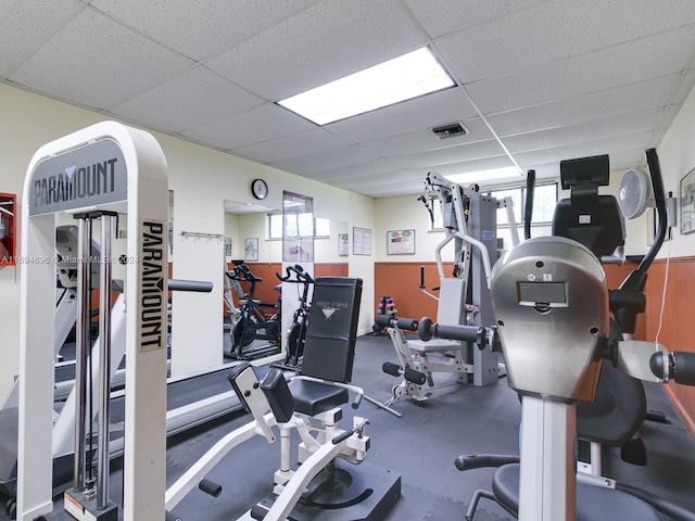 gym with a paneled ceiling