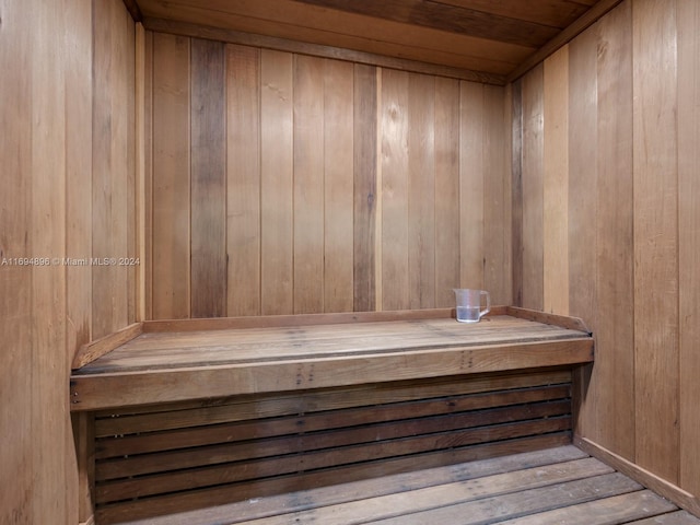 view of sauna with wooden walls and wood ceiling