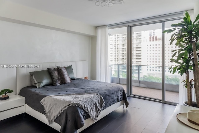 bedroom with access to outside and a wall of windows