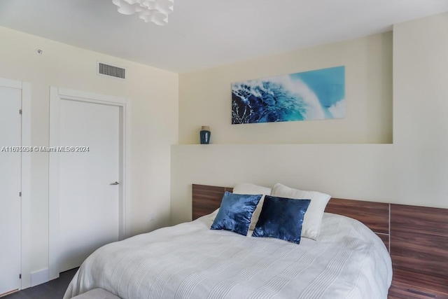 bedroom featuring wood-type flooring and a closet